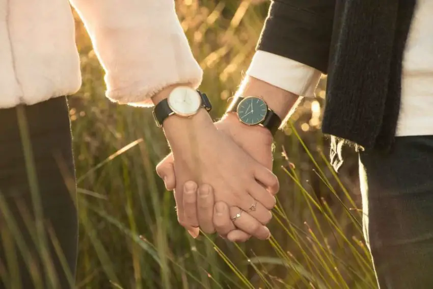 Man and woman with watches on their wrists.