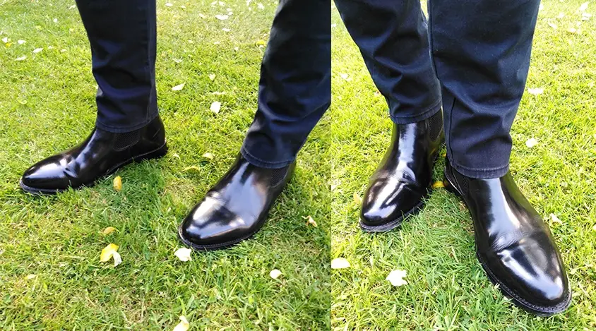 A man wearing black Chukka boots with navy chinos.